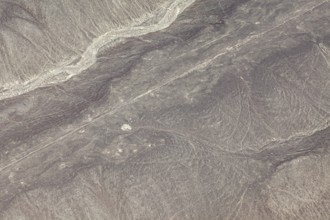 Dry, sandy landscape with distinctive lines and patterns, the geoglyphs and drawings in the desert