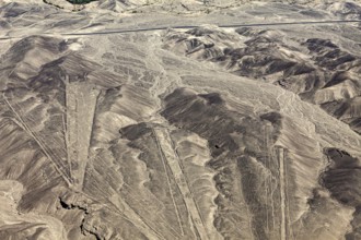 View of a dry desert landscape with clearly recognizable geoglyphs in the mountains, the geoglyphs