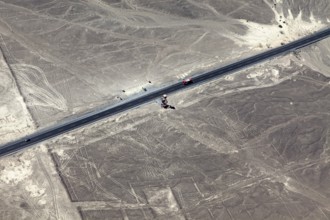 Aerial view of a road surrounded by geoglyphs and desert lines, the geoglyphs and images in the