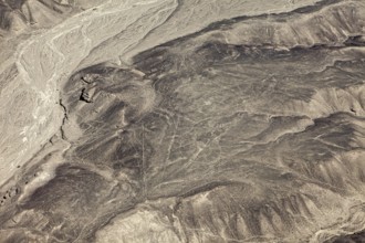 Wide expanse of a barren and dry landscape with eye-catching line patterns, geoglyphs and drawings
