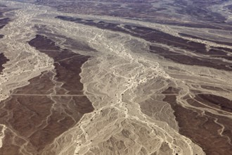 Aerial view of a desert landscape with distinctive sand patterns and lines, The landscape and