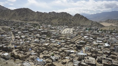 City view from Leh Palace over Leh with mountains and cloudy sky, Ladakh, North India, Himalayas,