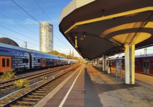 On the train track with a view of the Cologne Triangle skyscraper at sunrise, Deutzer Bahnhof,