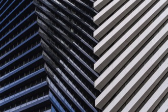 A captivating close-up view of modern skyscrapers, highlighting contrasting geometric patterns and