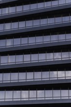 A detailed close-up showcasing the modern architectural design of a building's exterior. The image