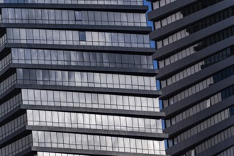 A detailed look at a modern skyscraper featuring geometric patterns formed by windows and