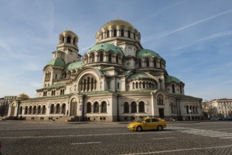 Sofia, Bulgaria, February 6th 2018 Bulgarian Taxi passing Alexander Nevsky Cathedral, Sofia.