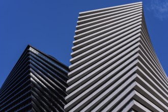 From below striking image of modern architecture showcasing geometric patterns and contrasting