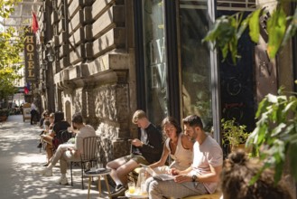 Bucharest, Romania. October 29th 2023. Young people relax outside a popular cafe in Grand Old Town