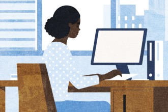 A businesswoman sits at a wooden desk in a contemporary office, focused on her work at a computer