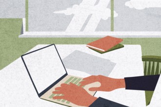 A person is using a laptop at a bright and airy workspace with large windows Papers and notebooks