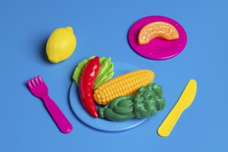 Colorful plastic food portrays junk food culture, critiquing modern diet trends Toys represent