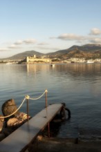 Beautiful morning light on Bodrum harbour with a medieval fortress and mountains in the background,