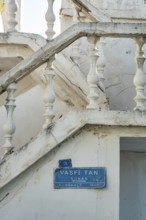 Bodrum, Mugla, Turkey. April 23rd 2022 Blue street sign for Vasfi Tan Sokak and traditional white