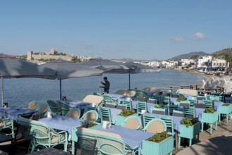 Bodrum, Mugla, Turkey. April 21st 2022 A waiter prepares tables on the beach side cafe in Bodrum