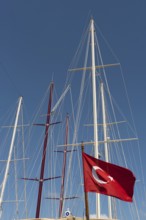 Dramatic abstract view of the masts of sailing boats in a Turkish harbour on the Aegean Sea in