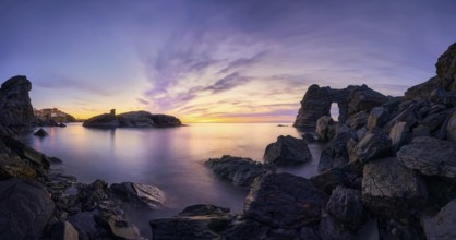 A stunning sunset at Cala Flores, Cabo de Palos, Cartagena, Murcia, featuring rugged coastal rocks,