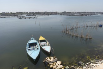 Small fishing boats and fish traps near the fish farms of Rashid on the River Nile, Rosetta, Egypt