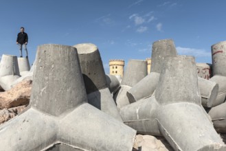 Alexandria, Egypt. December 1st 2022 Young Egyptian man standing on massive concrete blocks