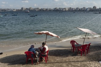 Alexandria, Egypt. December 1st 2022 An Egyptian couple sit on the receding Mediterranean beach of