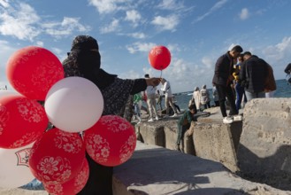 Alexandria, Egypt. December 3rd 2022 A Muslim woman wearing a black abaya and niqab selling