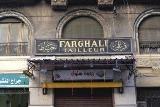 Alexandria, Egypt. December 4th 2022 French and Arabic shop sign for Farghali Tailleur, colonial