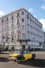 Alexandria, Egypt. December 4th 2022 Egyptian taxi passing the famous Trianon Cafe restaurant, Saad