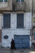 Alexandria, Egypt. December 3rd 2022. Blue painted doors and windows of faded traditional