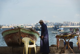 Alexandria, Egypt. December 1st 2022 An informal tourist souvenir stall beside a fishing boat on