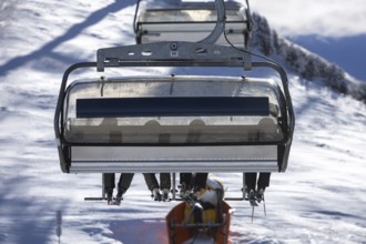Symbolic picture of skiing: View of a group of skiers on a chairlift