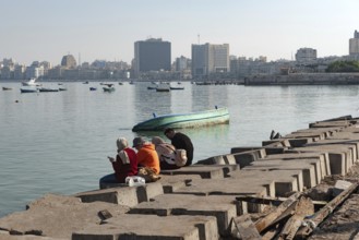 Alexandria, Egypt. December 1st 2022 People on concrete blocks positioned as a defence against