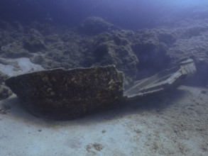 An underwater shipwreck in a dark, rocky environment. Fraskeric dive site, Stoja, Pula, Croatia,