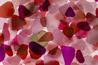 Red broken glass cut by the sea, sea glass, sea glass, beach glass from the North Sea