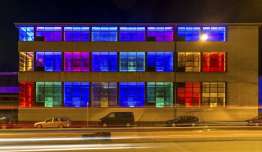 Colourfully illuminated window front in a Frankfurter Mainova AG building, city center, Frankfurt