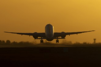 Boeing 777 A7-BFL commercial jet aircraft of Qatar cargo taking off in flight silhouette at sunset