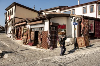 Ankara, Turkey. November 17th 2020 Traditional Turkish Simit seller walking past Antique carpet