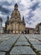 Close-up of the Church of Our Lady in Dresden seen across cobblestones with dramatic sky, Dresden