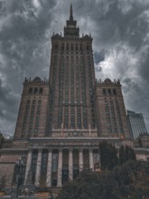 Dominant Palace of Culture in Warsaw against a dramatically cloudy sky with neoclassical style