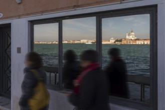 Santa Maria della Salute is reflected in a shop window on the island of Giudecca, Venice, Veneto,