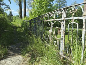 An old, rusty iron fence along a grassy path, Upper Franconia