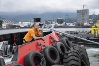 Batumi, Georgia. July 21st 2025. A local worker at Batumi Port, largest container, ferry, general