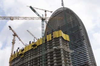 Batumi, Georgia. July 21st 2025. Cranes and construction work on modern high-rise hotel and