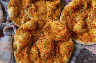 Delicious Turkish Biberli Ekmek Flat bread with red pepper paste fresh from cooking in a