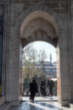 Istanbul, Turkey. January 3rd 2025. Muslim women entering the arched door at the entrance to newly