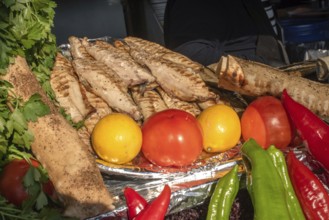 Tasty looking grilled mackerel and fresh vegetables ready to prepare Balik Ekmek, a traditional