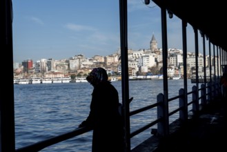 Istanbul, Turkey. January 3rd 2025. A Turkish Muslim woman on the Galata bridge that crosses the