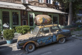 Tbilisi, Georgia. July 29th 2025. An old brightly decorated car being used to promote a wine shop