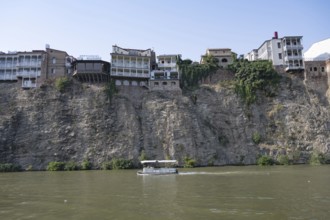 Tbilisi, Georgia. July 29th 2025. Hotels and other building sit precariously on a cliff above the