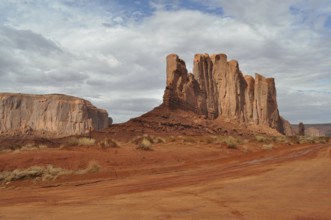 Impressive rock formations stand in a vast red desert landscape, Monument Valley, Navajo Tribal