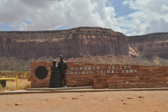 Sign at the entrance to Monument Valley, which is surrounded by impressive rock formations,